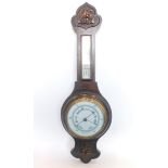 A 20thC two dial oak cased banjo barometer thermometer, with 16cm diameter main dial in a heavily ca