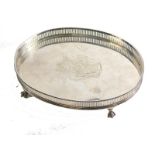 A Charles III silver tray, of oval form with galleried edge, central crest on ball and claw feet, ma