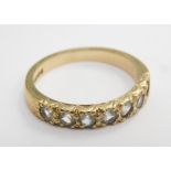 A 9ct gold cz half hoop dress ring, set with seven round brilliant cut stones, each in claw setting,