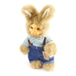 A Robert Raikes original rabbit teddy bear wearing dungarees, marked Everyone Loves to Get Applause,