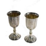A pair of 20thC silver plated communion goblets, each with bell shaped bowls and floral feet, 23cm h