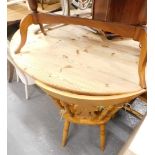 A pine circular table: Auctioneer Announce chairs removed from this lot.