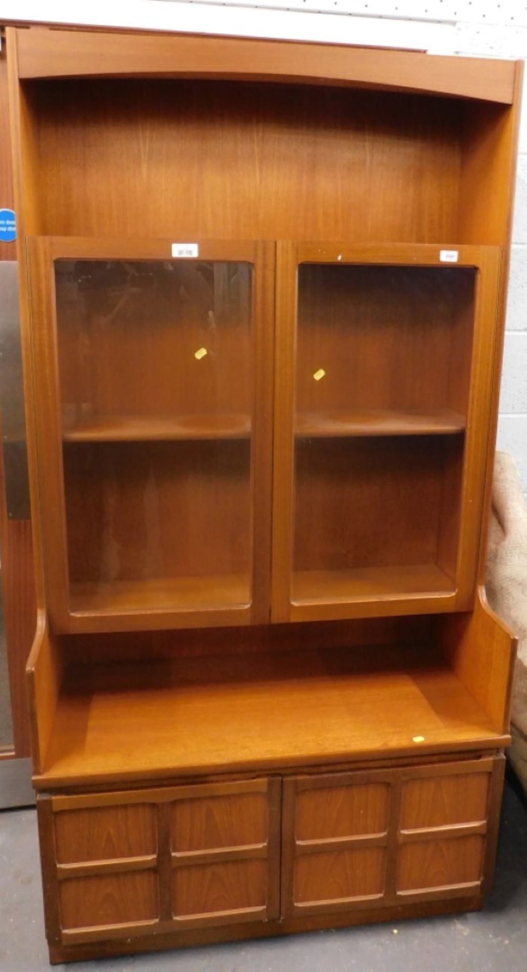 A Nathan teak side cabinet, with two glazed doors and two panelled doors.
