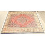 A large machine woven rug in floral pattern, predominately in blue, cream and red, 363cm x 276cm.