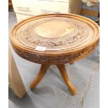 A heavily carved Eastern hardwood side table.