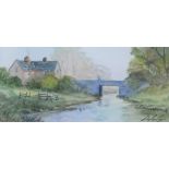 Digby Page (b.1945). Calm stream and bridge before cottage and trees, watercolour, signed, 10cm x 20