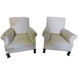 A pair of early 20thC armchairs, upholstered in white calico, on short cabriole legs, with pad feet.