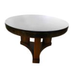 An Art Deco mahogany and calamander display table, with a circular glazed top, on four square sectio