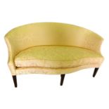 A mahogany concave shaped sofa, upholstered in pink striped Damask fabric, with a loose cushion, on