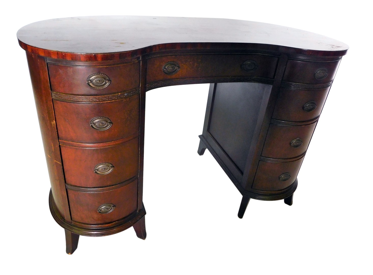 A mahogany kidney shaped desk or dressing table, with an arrangement of nine drawers, each with oval