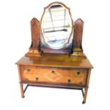 An early to mid 20thC walnut mirror back dressing table, the shaped bevel plate on quarter veneered