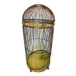 A patinated brass and gilt large parrot cage, with scroll frieze, plain sides, and a galleried tray