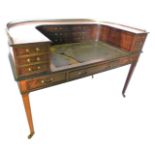 A late 19thC mahogany and ebonised Carlton House desk, the raised top with a pierced brass gallery a