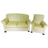 A three piece suite, comprising two seat sofa, and two armchairs, upholstered in white calico, on bu