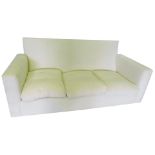 A plain square three seater settee, upholstered in white calico, 220cm wide