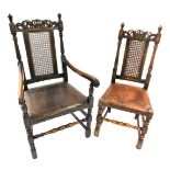 A set of four oak dining chairs, each with a carved crest with a crown, a cane insert and a brown le