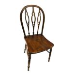 An early 20thC ash and elm Windsor side chair, with pierced Gothic shaped back, solid seat, on turne