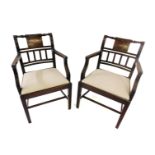 A pair of mid 19thC mahogany elbow chairs, each with a reeded frame, a marquetry tablet with shells,