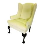 A George III mahogany winged back armed chair, upholstered in white calico, on cabriole legs with ca