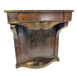 A late Regency figured mahogany console table, with recessed centre, plain frieze with two acanthus