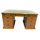 A Georgian style mahogany twin pedestal partners desk, with green inset leather top and three frieze