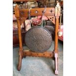 A Victorian Gothic oak dinner gong, with carved enchamfered frame, and large hammered gong with two