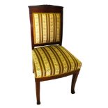 An early 19thC mahogany French Empire side chair, with a carved back rail, padded back and seat, on