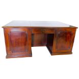 A 19thC mahogany partner's kneehole desk, the rectangular top with a black tooled leather inset and