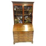 A George III mahogany bureau bookcase, with key moulded cornice and blind fret carved frieze, quarre