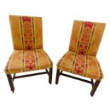 A pair of mid to late 18thC side chairs, each with a padded back and seat, upholstered in gold and r