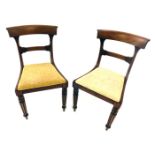 A pair of William IV mahogany side chairs, each with a bar back, drop in seat, on turned and reeded