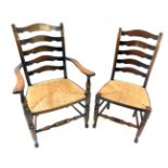 A set of six late 19th/early 20thC country made oak ladder back dining chairs, each with a rush