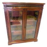 A late Victorian mahogany bookcase, enclosed by two glazed doors and having two adjustable shelves,