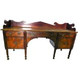 An early 19thC mahogany sideboard, the top with a shaped raised gallery and a moulded edge, above an