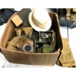 A large box of assorted militaria, to include gas mask, webbing pouches, gaiters, torch, etc.