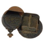 Two World War II black out car headlamp covers.