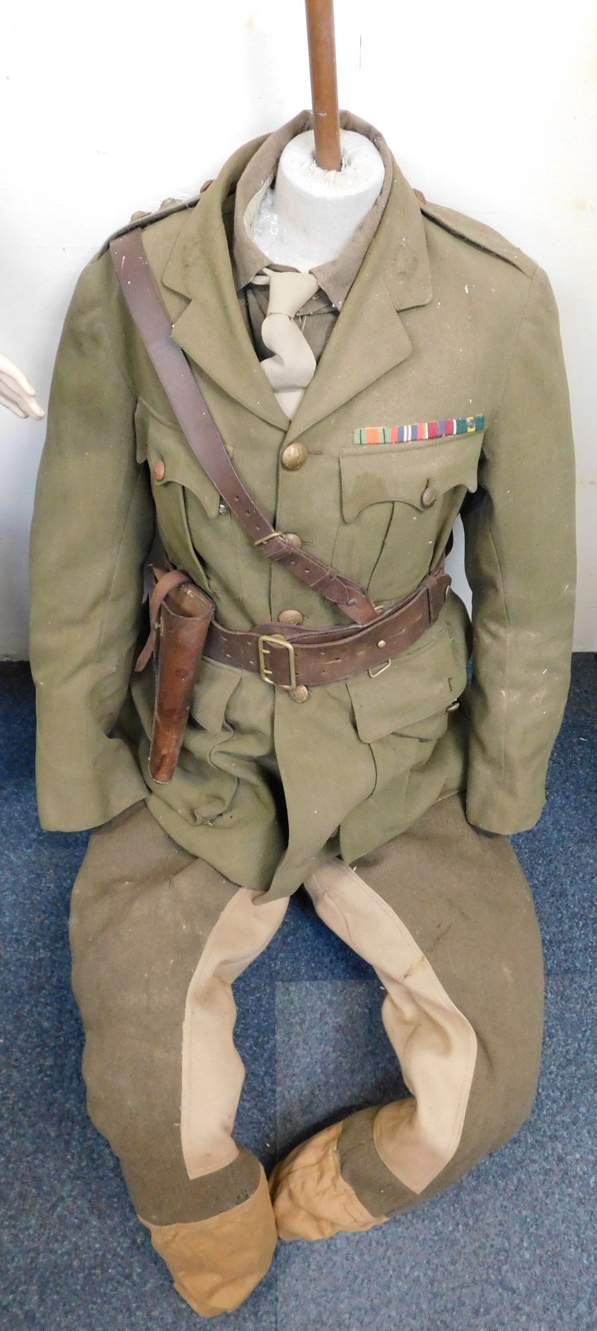 A male torso dressed in World War II period Royal Signals officer's tunic, complete with Sam Browne