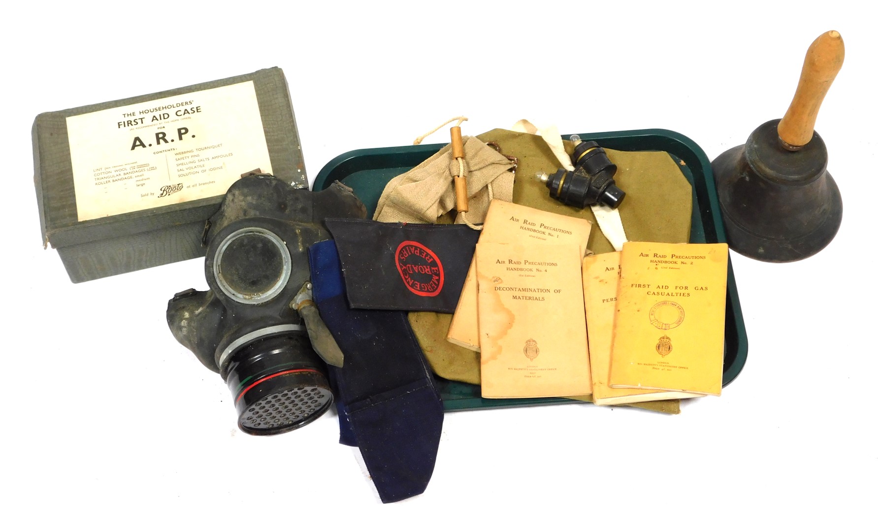 A selection of World War II Home Front items, to include gas mask, fire guard arm bands, ARP first a