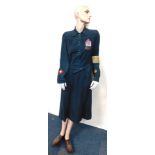 A female mannequin wearing WVS Women's Voluntary Service style dress.