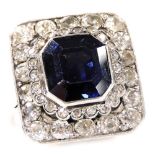 A sapphire, diamond and platinum ring, the canted rectangular central sapphire collet set in a two t