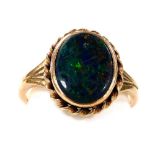 A 9ct gold opal doublet ring, in an oval setting with a rope twist surround, size O, 4.1g.