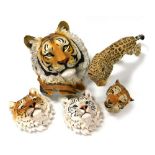 A group of resin wall masks, modelled as tiger's heads, and a further figure of a leopard. (5)