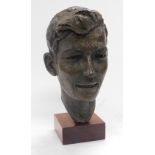 A 20thC hollow cast bronze bust of a gentleman, raised on a wooden base, 35cm high.