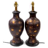 A pair of brown glazed ceramic table lamps, of baluster form, with raised foliate and scrolling leaf