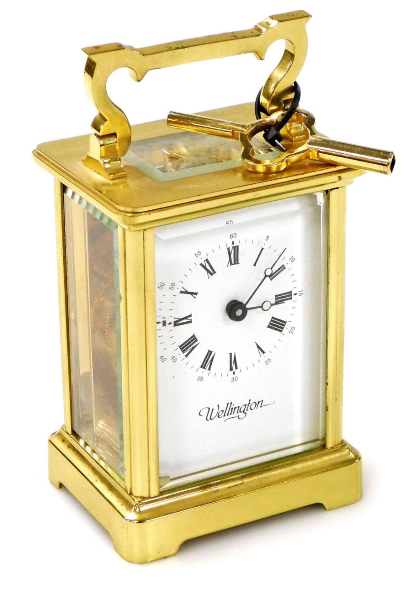 A 20thC brass cased carriage clock, the white enamel dial bearing Roman numerals for Wellington, key