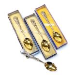 A set of four George V silver golfing related teaspoons, each handle cast with golf clubs and balls,