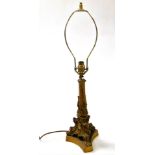 A late 19thC brass candlestick base, converted to a table lamp, of rococo form, raised on a triform