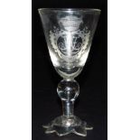 A late 18thC Continental wine glass, the trumpet shaped bowl engraved with a jewelled shield, monogr