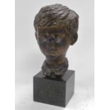 A 20thC bronze bust of a boy, signed indistinctly, raised on a cube form green marble base, 41cm hig