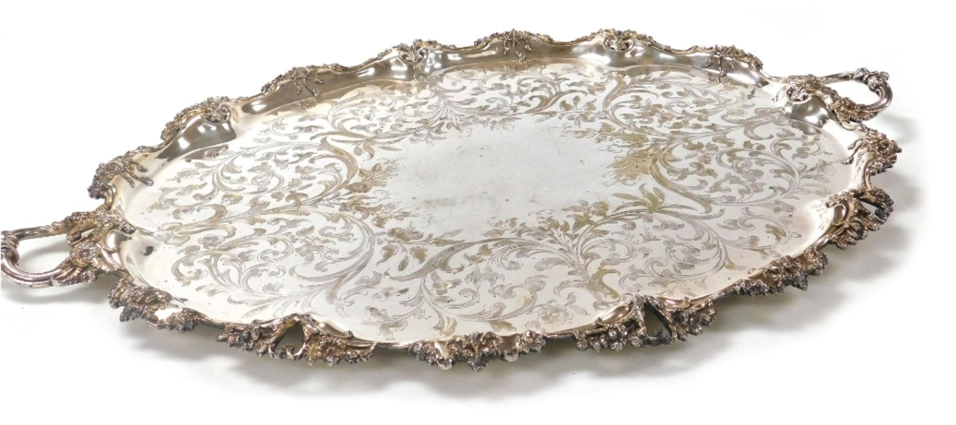 A Victorian silver plated twin handled tray, with central floral and foliate engraving, within a rai